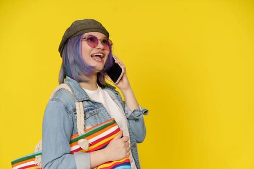 Intersection Of Technology, Shopping, And Cheerful Lifestyle. Asian Girl Has Phone Call, While Holds Shopping Bag On Shoulder Isolated On Yellow With Copy Space. . High quality photo