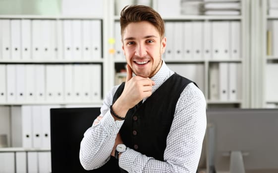 Handsome man in suit and tie stand in office looking in camera hands crossed on chest. White collar dress code modern office lifestyle graduate college study profession idea coach train concept