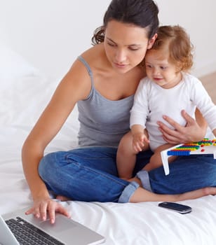 Laptop, baby and mother in bedroom for remote work, learning or online education in home. Freelancer parent, computer and kid on bed playing with abacus, child care and toddler together with family.