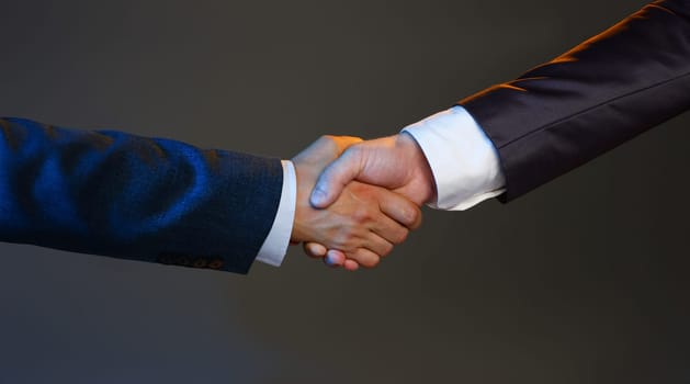 Man in suit shake hand as hello in office closeup. Friend welcome mediation offer positive introduction greet or thanks gesture summit participate approval motivation strike arm bargain concept