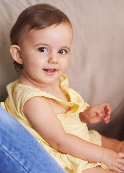 Baby, portrait and sitting on couch, child development and infant growth with face, happy and home. Girl, joyful and healthy in good mood, childhood and cheerful with enthusiasm, kid and adorable.