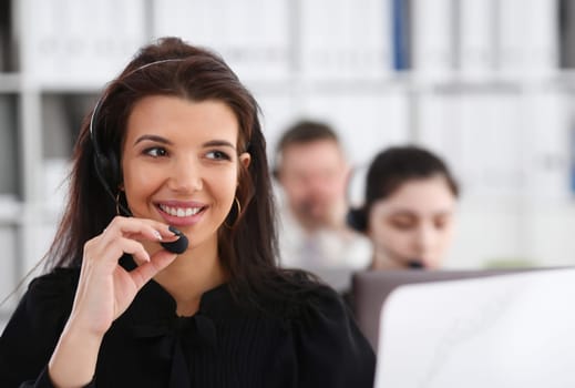 Three call centre service operators at work. Portrait of smiling pretty brunette woman at workplace employment effective mediation negotiation participation solve problem real time aid job concept