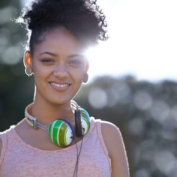 Portrait, student or happy woman at park with headphones at university campus outdoor in nature. Face, college and smile of girl or young person in education for learning to study at school in Brazil.
