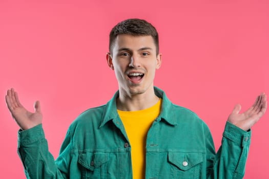 Shocked man glad, he screaming WOW. Impressed guy trying to get attention. Concept of summer sale, profitable offer. Excited happy on pink background. High quality