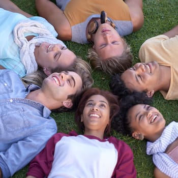 Top view, friends and group relax on grass at park on vacation, holiday or summer travel. Above, people smile and students on lawn at garden, circle in nature or freedom of community together outdoor.