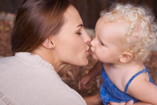 Mother, love and kiss of baby in house, trust and parent support for mama bond with happiness in care. Woman, nurture and toddler daughter with together, wellness and hug kid for bonding in apartment.