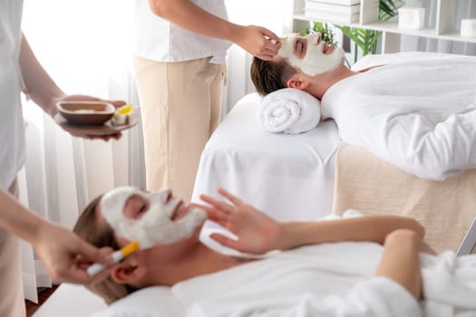 Serene ambiance of spa salon, couple indulges in rejuvenating with luxurious face cream massage with modern daylight. Facial skin treatment and beauty care concept. Quiescent