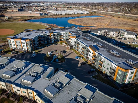 Captivating drone image of Stonebridge, Saskatoon, highlighting its harmonious blend of modern homes, parks, and amenities.