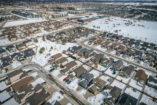 Captivating drone image of Stonebridge, Saskatoon, highlighting its harmonious blend of modern homes, parks, and amenities.