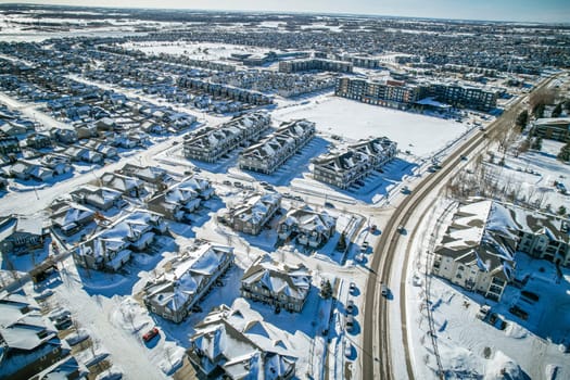 Captivating drone image of Stonebridge, Saskatoon, highlighting its harmonious blend of modern homes, parks, and amenities.