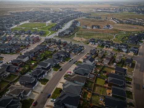 Elevated drone view of Rosewood, Saskatoon, showcasing its residential layout, green areas, and vibrant community life.