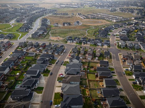 Elevated drone view of Rosewood, Saskatoon, showcasing its residential layout, green areas, and vibrant community life.