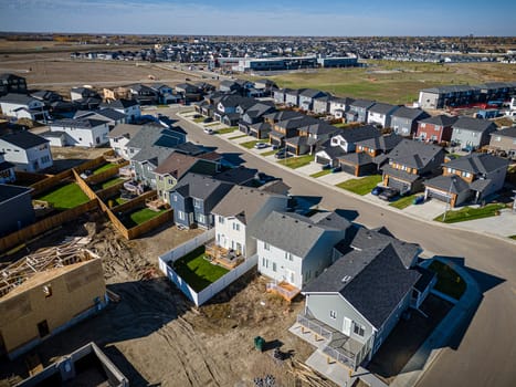 Elevated drone view of Rosewood, Saskatoon, showcasing its residential layout, green areas, and vibrant community life.