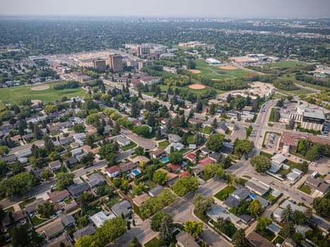 Elevated drone view of Rosewood, Saskatoon, showcasing its residential layout, green areas, and vibrant community life.