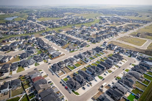 Elevated drone view of Rosewood, Saskatoon, showcasing its residential layout, green areas, and vibrant community life.