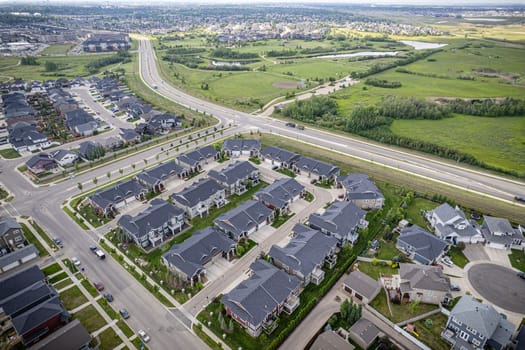 Elevated drone view of Rosewood, Saskatoon, showcasing its residential layout, green areas, and vibrant community life.