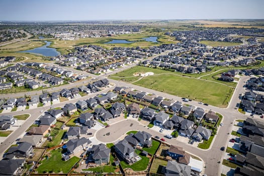 Elevated drone view of Rosewood, Saskatoon, showcasing its residential layout, green areas, and vibrant community life.