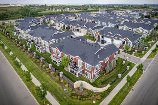 Elevated drone view of Rosewood, Saskatoon, showcasing its residential layout, green areas, and vibrant community life.