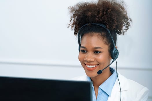 African American young businesswoman wearing headset working in office to support remote crucial customer or colleague. Call center, telemarketing, customer support agent provide service on video call