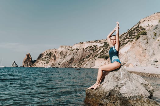 Woman beach vacation photo. A happy tourist in a blue bikini enjoying the scenic view of the sea and volcanic mountains while taking pictures to capture the memories of her travel adventure