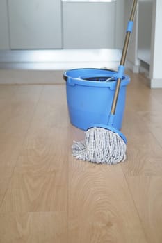 cleaning tiles floor with mop .