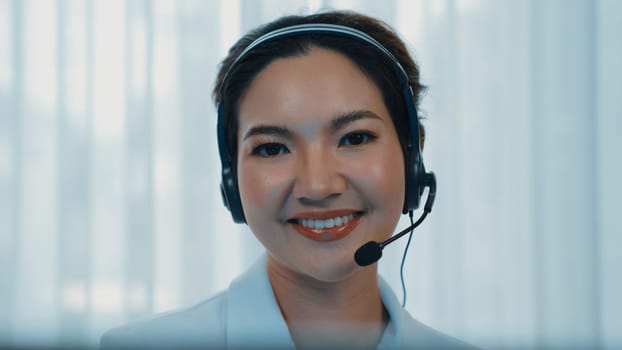 Businesswoman wearing vivancy headset working in office to support remote customer or colleague. Call center, telemarketing, customer support agent provide service on telephone video conference call