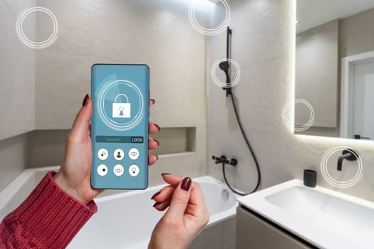All the house in a phone. Close up of young woman user hands controlling electronic objects in modern luxury studio apartment via smart home interface on cell screen. Internet of things ios technology.