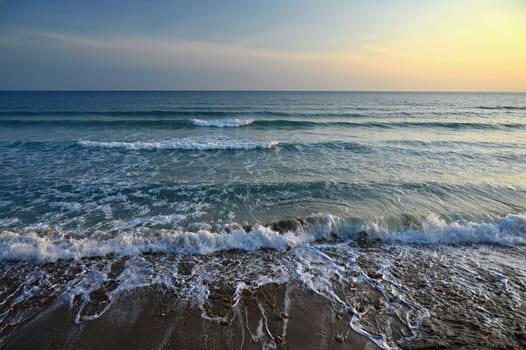 Sea at sunset with waves on the beach. Greece - the island of Corfu.