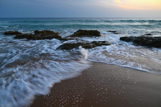 Sea at sunset with waves on the beach. Greece - the island of Corfu.