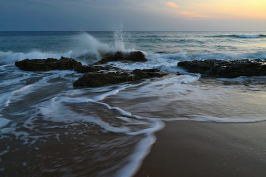 Sea at sunset with waves on the beach. Greece - the island of Corfu.