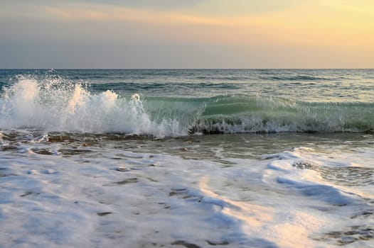 Sea at sunset with waves on the beach. Greece - the island of Corfu.