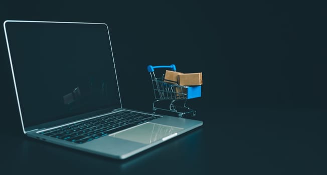 Boxes in a shopping car on a laptop keyboard. Ideas about online shopping, online shopping is a form of electronic commerce that allows consumers to directly buy goods from seller over the internet.