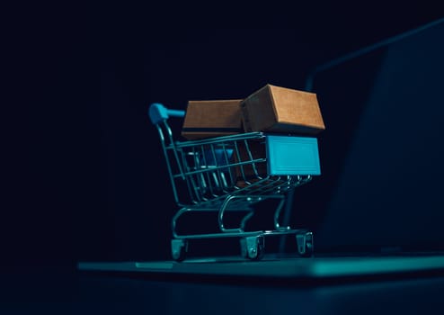 Boxes in a shopping car on a laptop keyboard. Ideas about online shopping, online shopping is a form of electronic commerce that allows consumers to directly buy goods from seller over the internet.