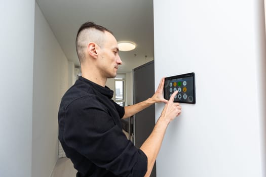 Man using smart home security system control panel. High quality photo