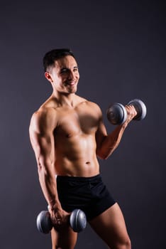 Portrait young fitness sporty strong man barechested muscular sportsman isolated on grey dark.