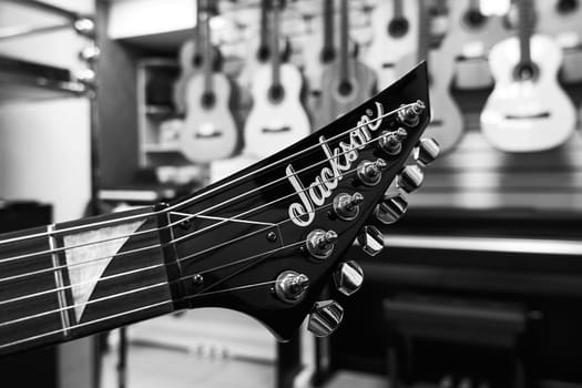 Ryazan, Russia - January 9, 2024: Jackson guitar headstock close up, black and white, selective focus