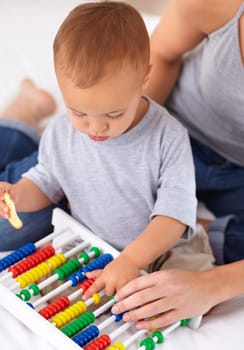 Abacus, toy and baby with mother playing, learning and teaching for child development on bed. Math, bonding and closeup of mom helping kid, infant or toddler with counting in bedroom at home