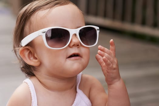 Baby, summer and sunglasses outdoor with silly, youth fashion and young girl on holiday. Kid, fun frames and eyewear on vacation with shades style, child clothes and trendy accessory of toddler.