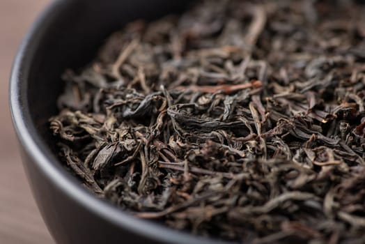 Dried leaves of black tea in bowl