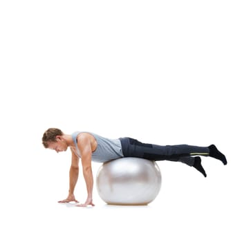 Man, fitness and exercise ball for workout, training or health and wellness against a white studio background. Active male person or athlete on round object for yoga or pilates on mockup space.