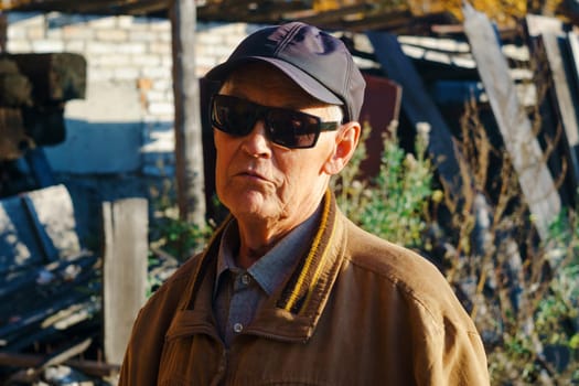 Portrait of an old man wearing sun protection glasses. Old grey haired grandpa central park walk positive enjoy sunny day weather stylish autumn jacket hot.