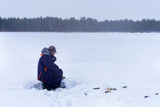 Man Holding in Hands rod. Winter fishing. Copy space. Winter activity. Copy space