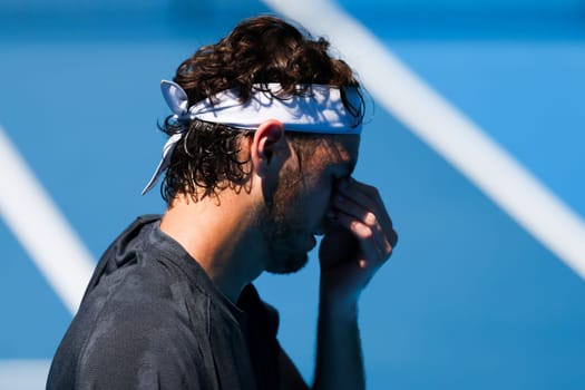 MELBOURNE, AUSTRALIA - JANUARY 12: Taylor Fritz of USA feels the heat whilst practicing with Daniil Medvedev of Russia ahead of the 2024 Australian Open at Melbourne Park on January 12, 2024 in Melbourne, Australia.