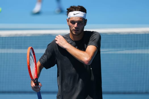 MELBOURNE, AUSTRALIA - JANUARY 12: Taylor Fritz of USA feels the heat whilst practicing with Daniil Medvedev of Russia ahead of the 2024 Australian Open at Melbourne Park on January 12, 2024 in Melbourne, Australia.