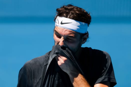 MELBOURNE, AUSTRALIA - JANUARY 12: Taylor Fritz of USA feels the heat whilst practicing with Daniil Medvedev of Russia ahead of the 2024 Australian Open at Melbourne Park on January 12, 2024 in Melbourne, Australia.
