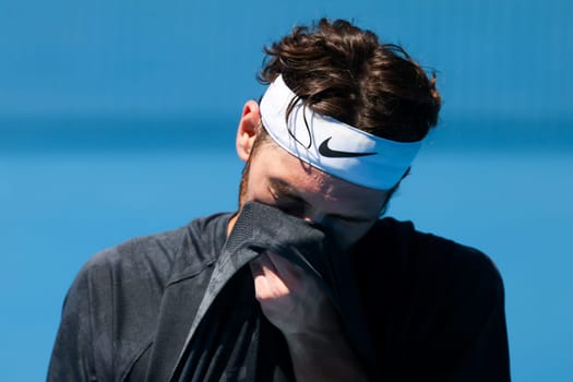 MELBOURNE, AUSTRALIA - JANUARY 12: Taylor Fritz of USA feels the heat whilst practicing with Daniil Medvedev of Russia ahead of the 2024 Australian Open at Melbourne Park on January 12, 2024 in Melbourne, Australia.