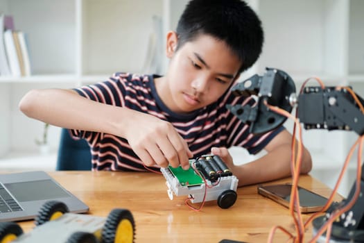 Student learning STEM education robotics for creating project studying for innovation robot models. New study generation for DIY electronic kits in mathematics engineering science technology computer code in computer technology classroom.