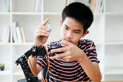 Student learning STEM education robotics for creating project studying for innovation robot models. New study generation for DIY electronic kits in mathematics engineering science technology computer code in computer technology classroom.