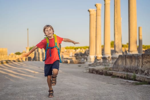 Boy tourist at the ruins of ancient city of Perge near Antalya Turkey. Traveling with kids concept.