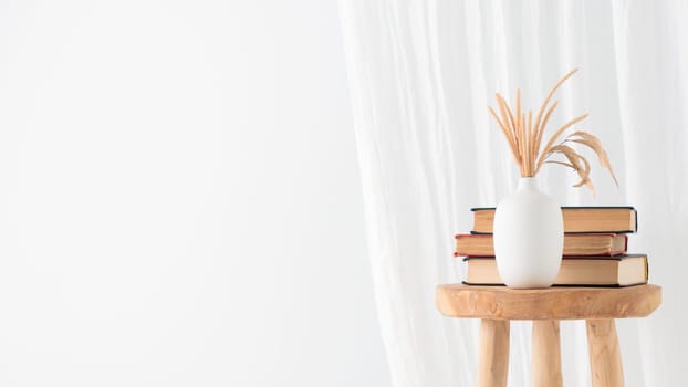 Wooden handcraft chair with books and vase on a white background